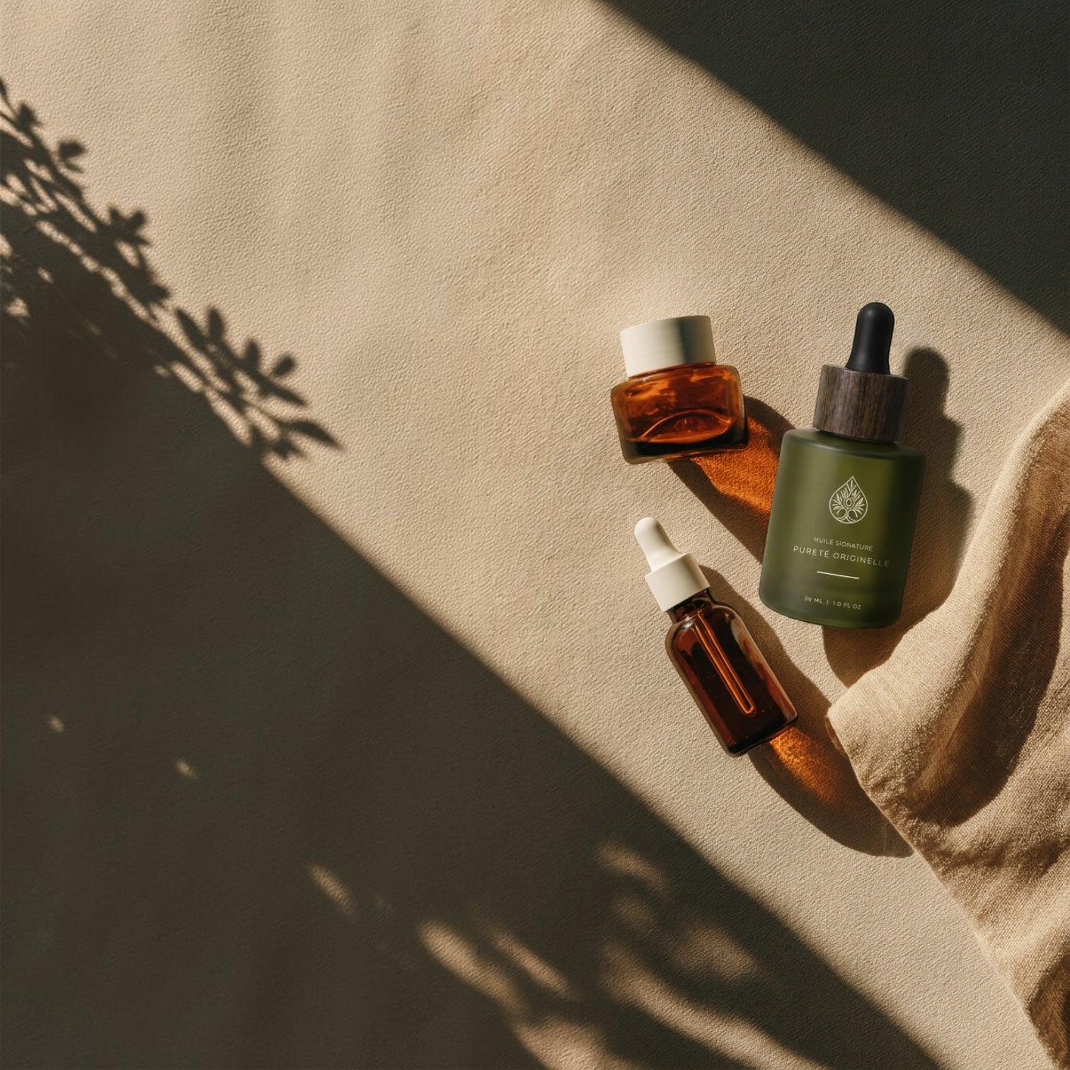 L'Arbre de paix Pureté Originelle fragrance-free signature oil bottles on a beige textured background with shadows.