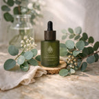 L'Arbre de paix Pureté Originelle fragrance-free signature oil in a frosted green glass bottle with a wooden dropper.